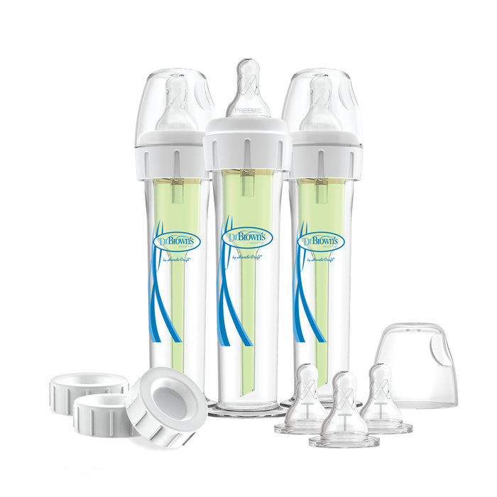 A set of three Dr. Brown's Accufeed Baby Bottles with Preemie Nipples (60cc), featuring green inserts and accompanied by extra bottle nipples, caps, and lids. These transparent bottles, displaying their labels and designs, are engineered to help reduce colic through a specialized venting system.