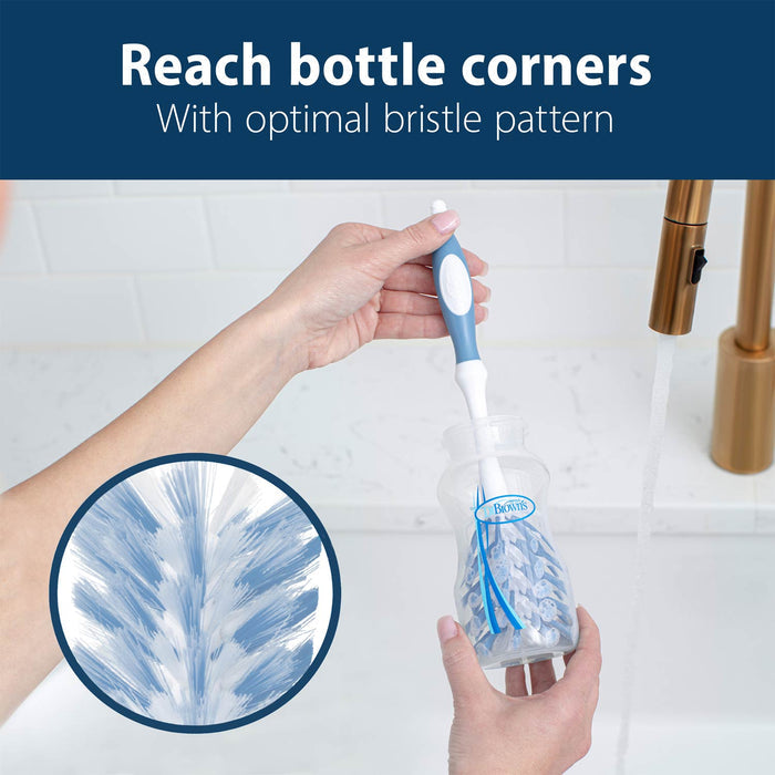 Person cleaning bottle with deluxe bottle brush over a sink