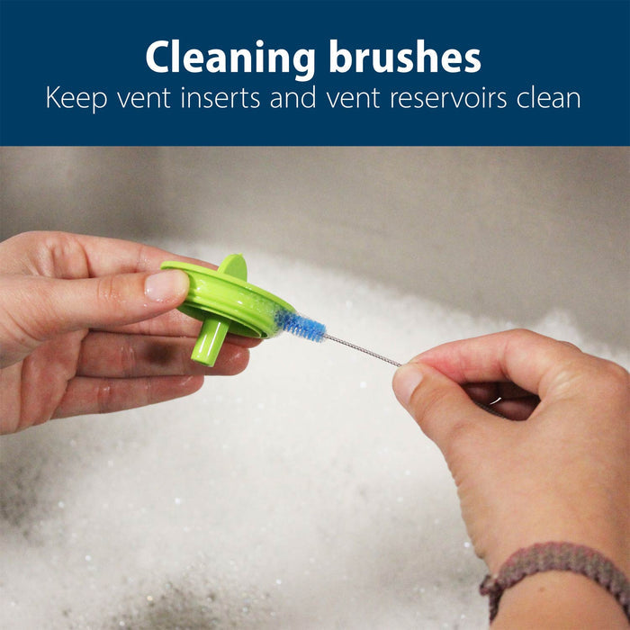 Person cleaning vent insert with cleaning brush