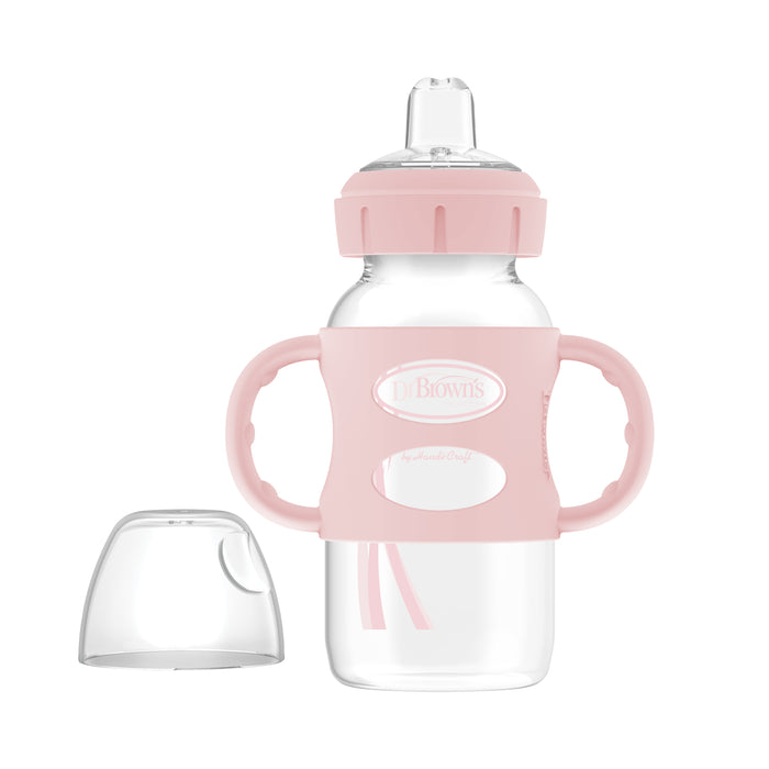 Dr. Brown’s Milestones Wide-Neck Sippy Spout Bottle, 9 oz, features pink silicone handles, a pink cap, a clear body, and a silicone sippy spout—ideal for your baby's transition from bottle to cup. Includes separate clear plastic cover.