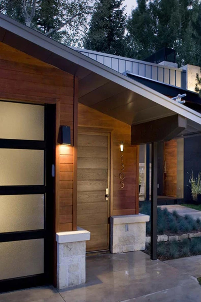 Mills Exterior Wall Light installed beside modern exterior entryway creating subtle architectural lighting
