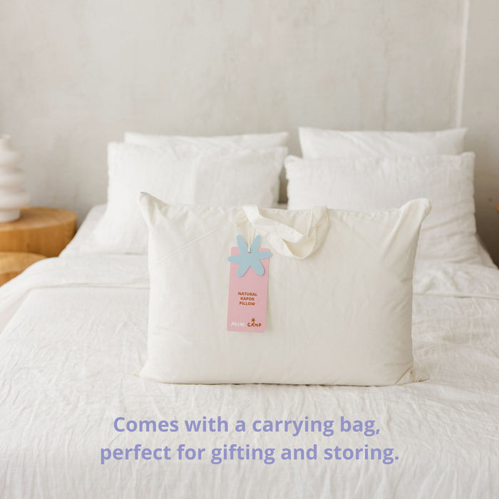 White pillow with a carrying bag on a bed, with text about the carrying bag.