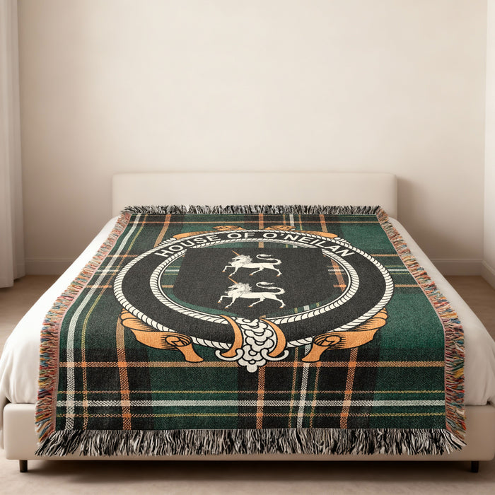 O'Neil family crest emblem woven blanket displayed on a bed