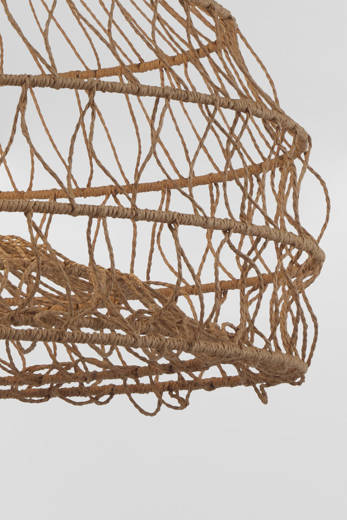 Close up detail of woven rattan pendant light showcasing layered organic cane weave construction