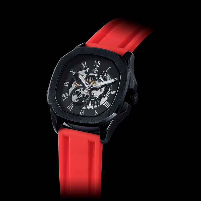Statement luxury watch with a black case, skeleton dial featuring Roman numerals, and a Red Silicone Strap With Silver Buckle, crafted to be bold by design.