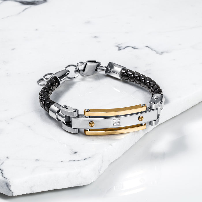 The Astro Diamond Bracelet for men featuring a black braided leather band, polished silver and gold-tone metal accents, and cubic zirconia detail, bold by design.