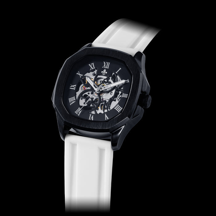 Close-up of a men's luxury watch with a black case featuring Roman numeral markers and a skeleton dial, paired with a White Silicone Strap With Rose Gold Buckle, bold by design.